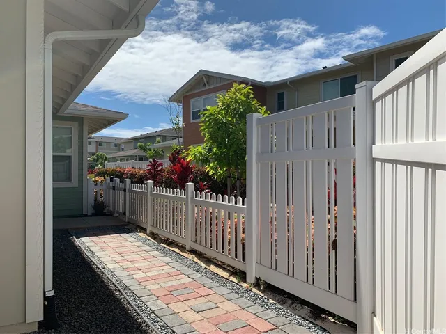 a view of a house with wooden fence