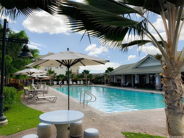 a view of a swimming pool with a patio and a garden