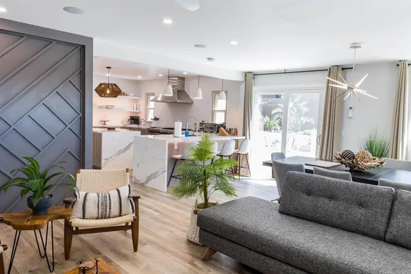 a room with a chandelier and a flat screen tv