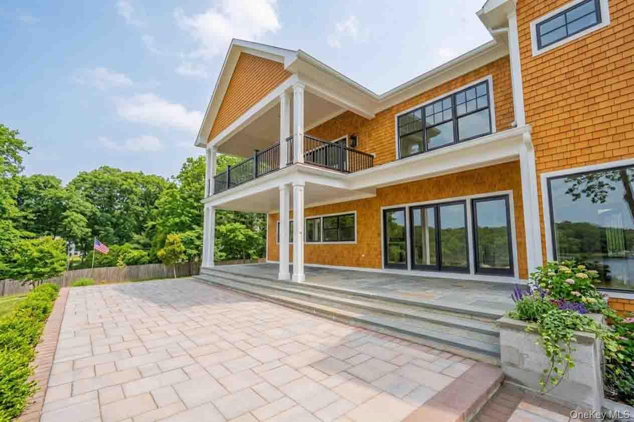 106 Cove Road Asharoken, NY 11768 - Photo 35 of 46 Rear view of house featuring a balcony and a patio area