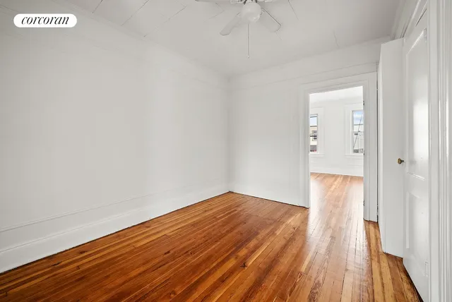 a view of a room with wooden floor and white walls