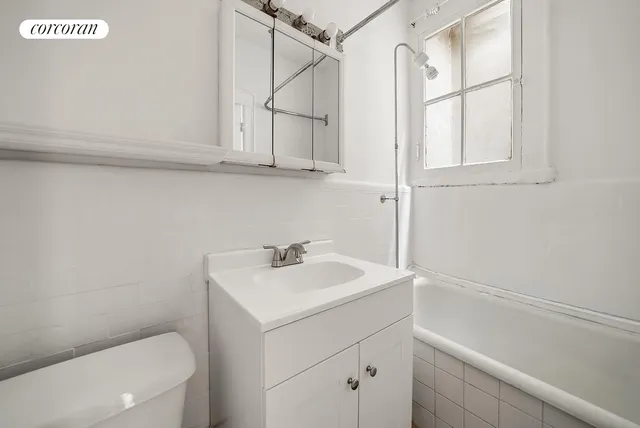 a bathroom with a sink a toilet and vanity