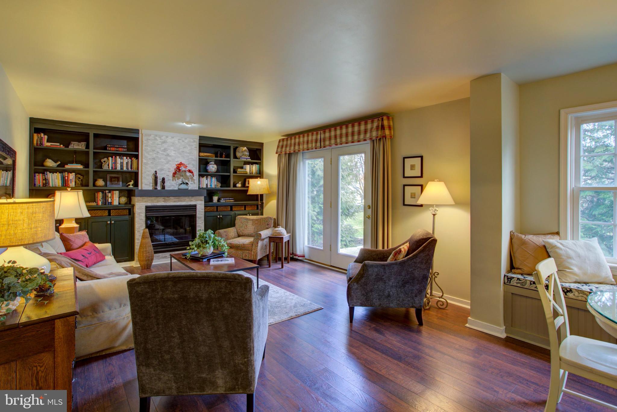 239 Kingsbridge Drive Lititz, PA 17543 - Photo 7 of 37 a living room with furniture fireplace and a large window