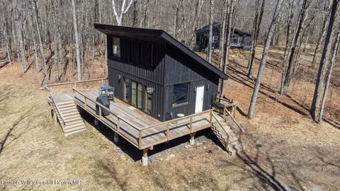 a view of a house with backyard and wooden fence