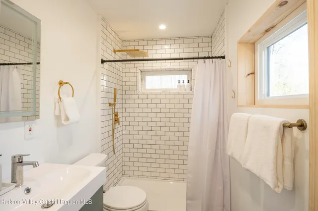 a view of a house with a wooden fence and two windows