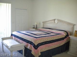 20281 Calice Court, Unit 2201 Estero, FL 33928 - Photo 3 of 8 a bedroom with a bed and window