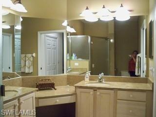 20281 Calice Court, Unit 2201 Estero, FL 33928 - Photo 7 of 8 a bathroom with a sink vanity and a mirror