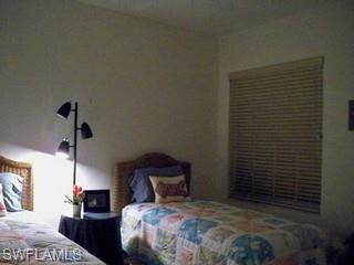 20281 Calice Court, Unit 2201 Estero, FL 33928 - Photo 8 of 8 a bedroom with a bed and a lamp on the dresser