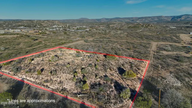 a view of a dry yard with mountains in the background