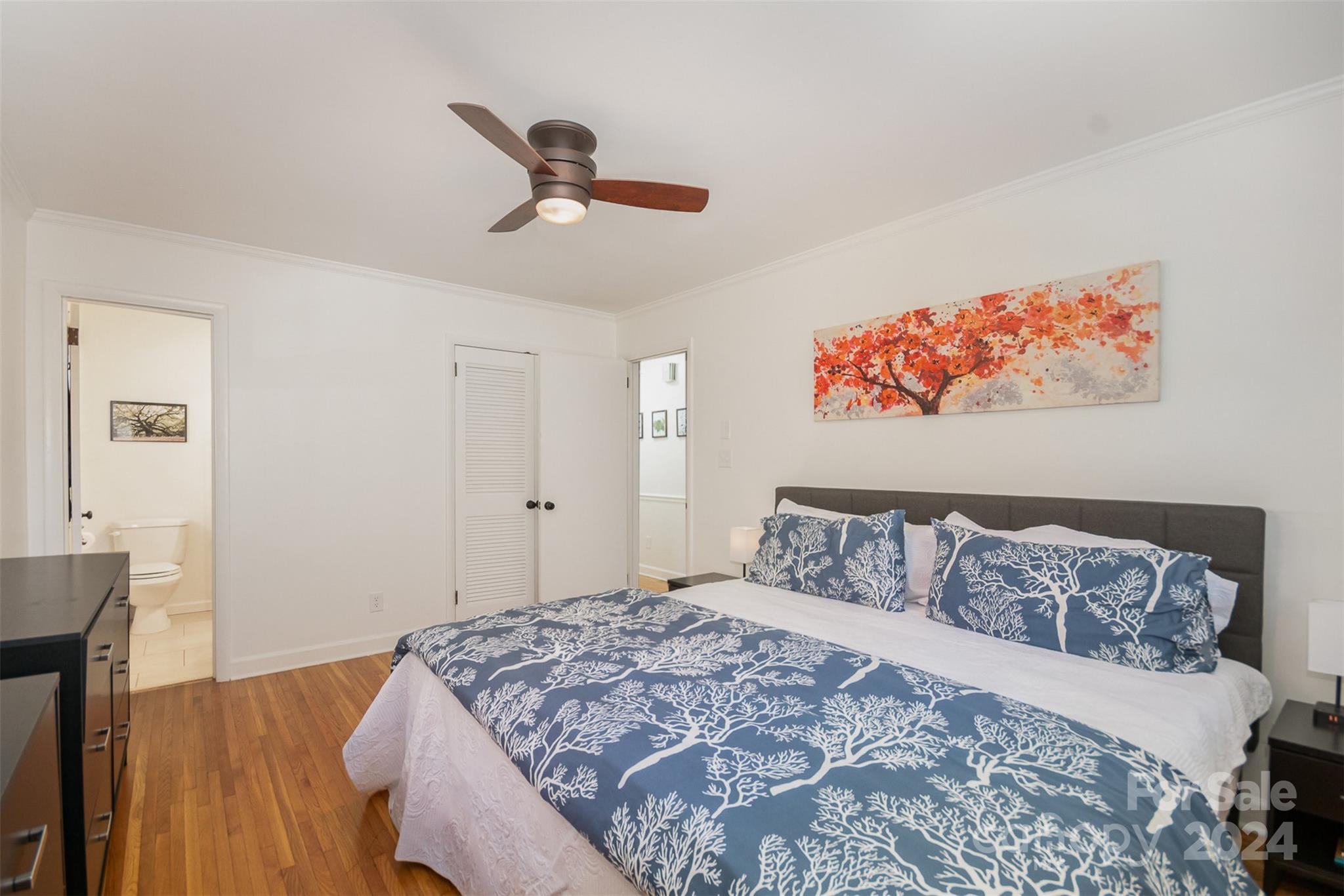3901 Sulkirk Road Charlotte, NC 28210 - Photo 14 of 24 a bedroom with a bed and wooden floor