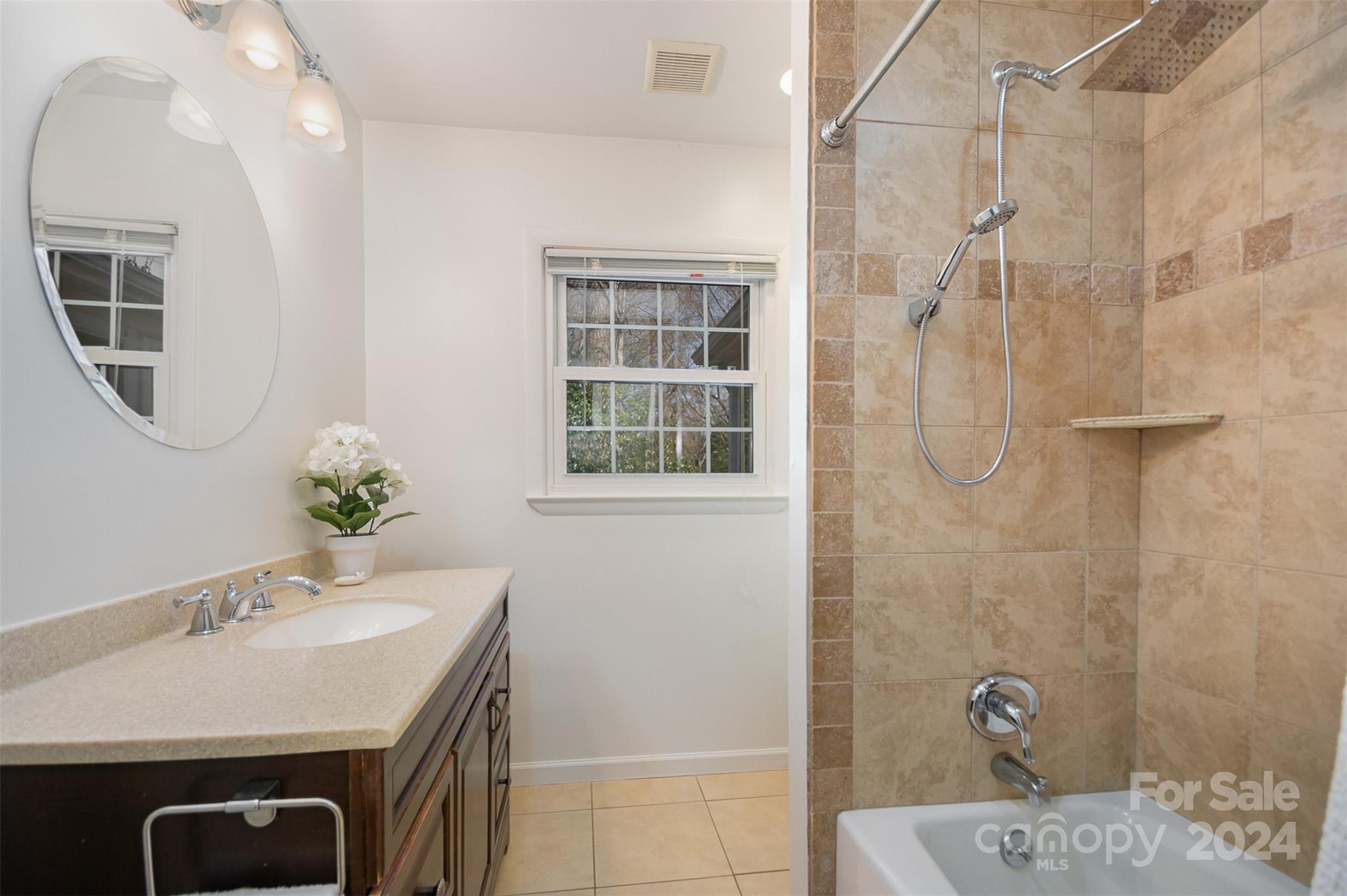 3901 Sulkirk Road Charlotte, NC 28210 - Photo 18 of 24 a bathroom with a sink a mirror and a shower