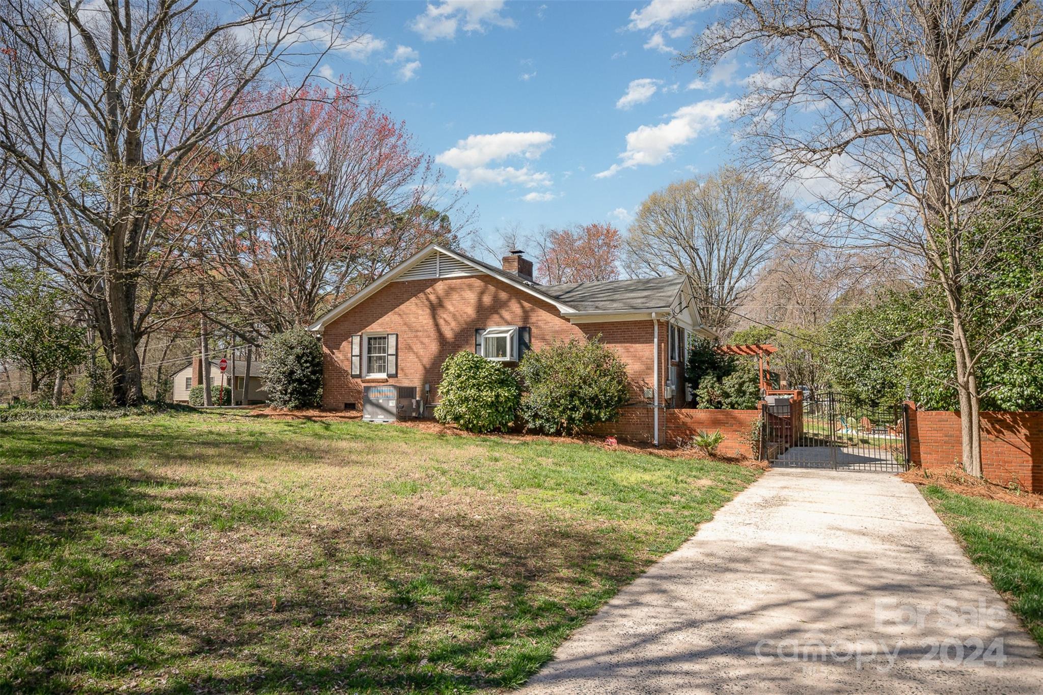 3901 Sulkirk Road Charlotte, NC 28210 - Photo 3 of 24 a front view of a house with a yard and trees