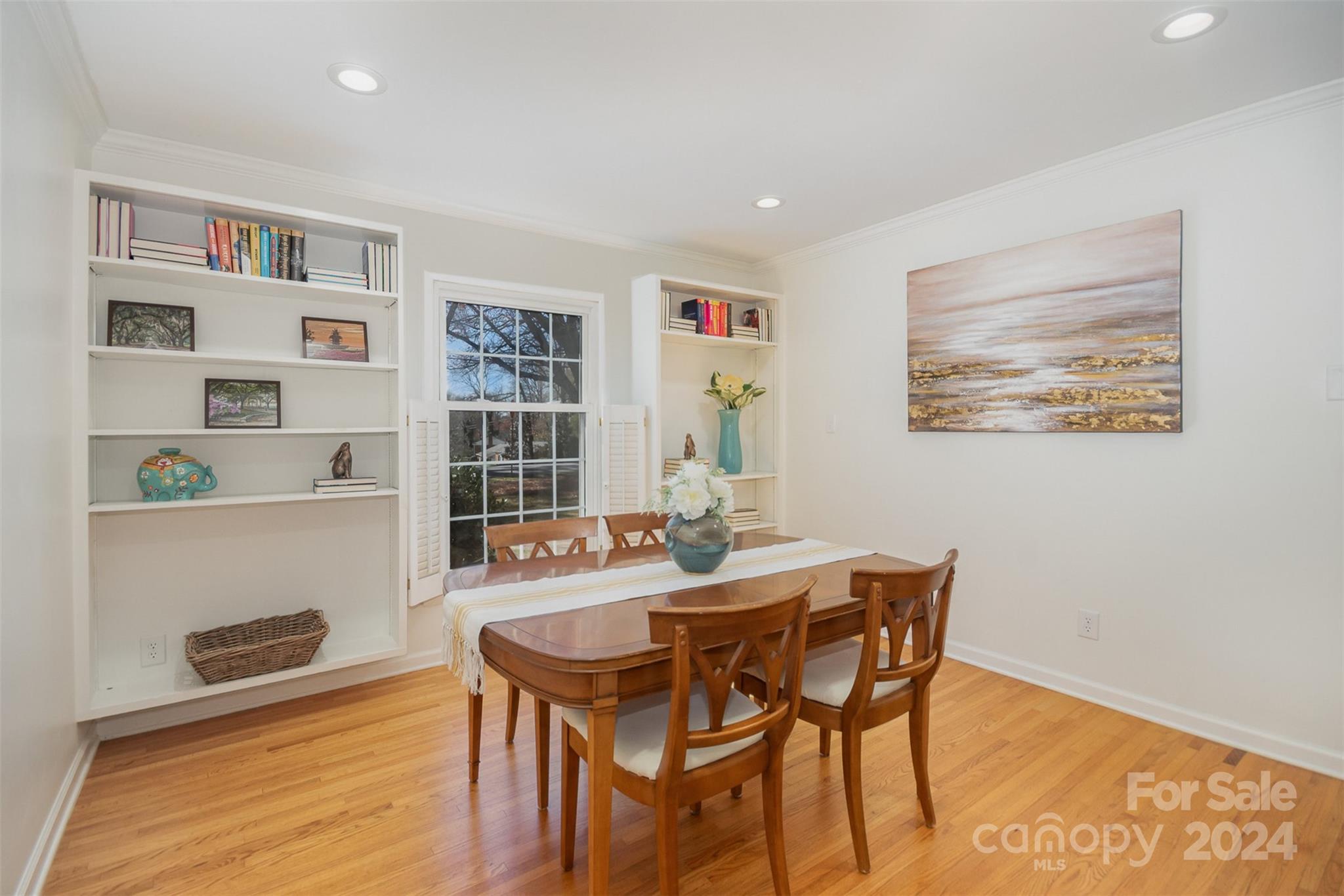 3901 Sulkirk Road Charlotte, NC 28210 - Photo 7 of 24 a dining room with furniture and a book shelf