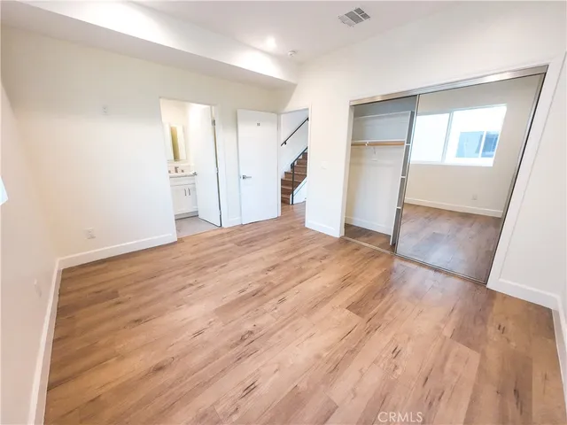 a big room with wooden floor and entryway