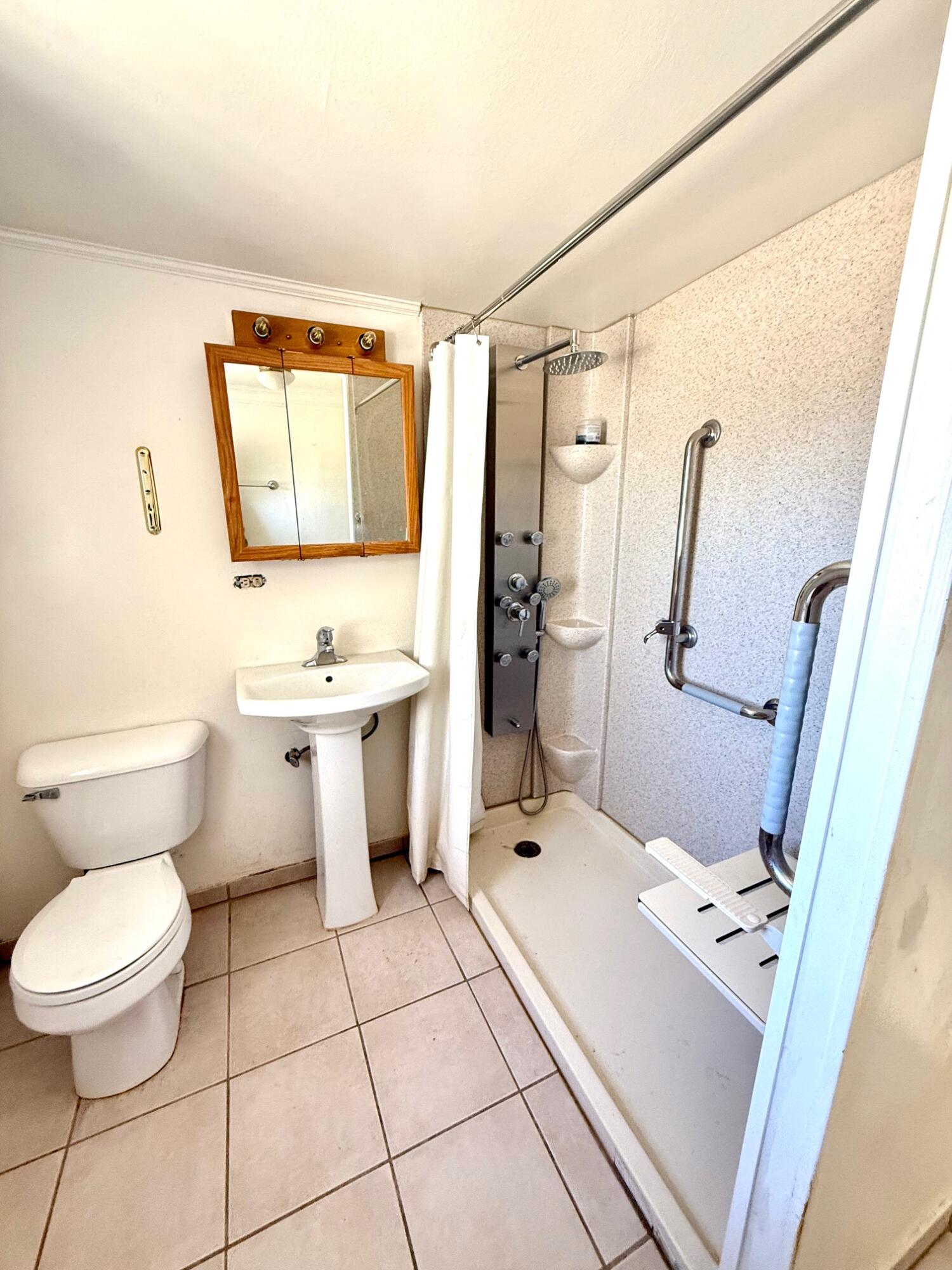 7990 Ramas Avenue Yucca Valley, CA 92284 - Photo 7 of 19 a bathroom with a sink toilet and shower