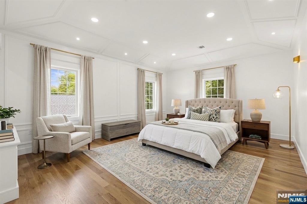 14 Beechwood Road Ho-Ho-Kus, NJ 07423 - Photo 13 of 31 a spacious bedroom with a bed a couch and a potted plant