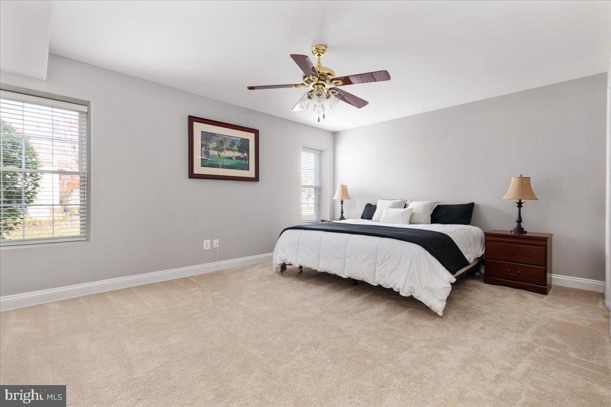 13612 Ryton Ridge Lane Gainesville, VA 20155 - Photo 38 of 83 a bedroom with a bed and a chandelier
