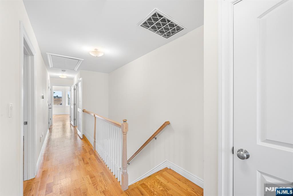 233 5th Street, Unit B Fairview, NJ 07022 - Photo 16 of 31 a view of a hallway with wooden floor and staircase
