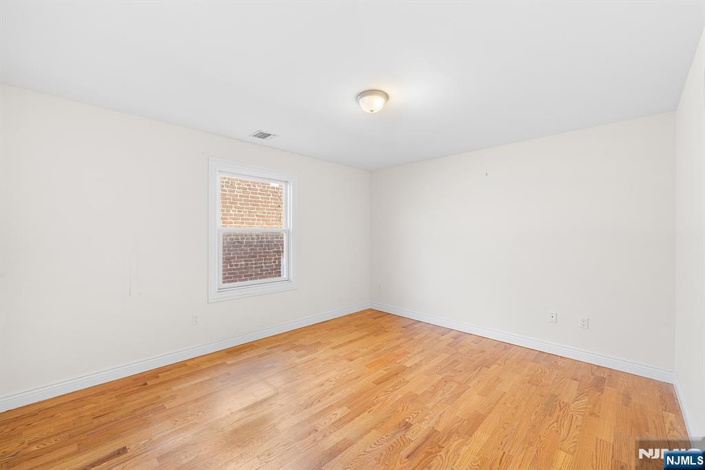 233 5th Street, Unit B Fairview, NJ 07022 - Photo 17 of 31 an empty room with a window