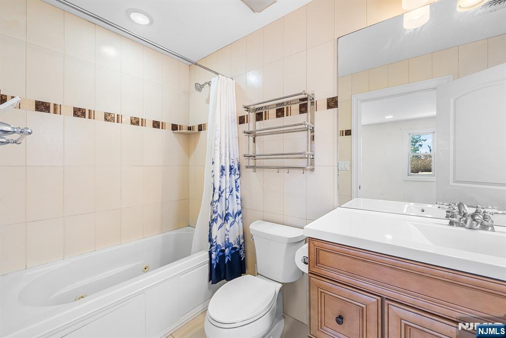 233 5th Street, Unit B Fairview, NJ 07022 - Photo 24 of 31 a bathroom with a sink toilet and shower