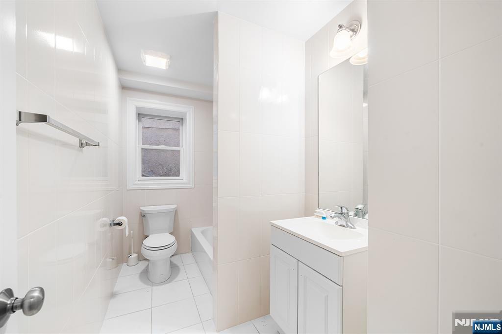 233 5th Street, Unit B Fairview, NJ 07022 - Photo 26 of 31 a bathroom with a sink toilet and shower