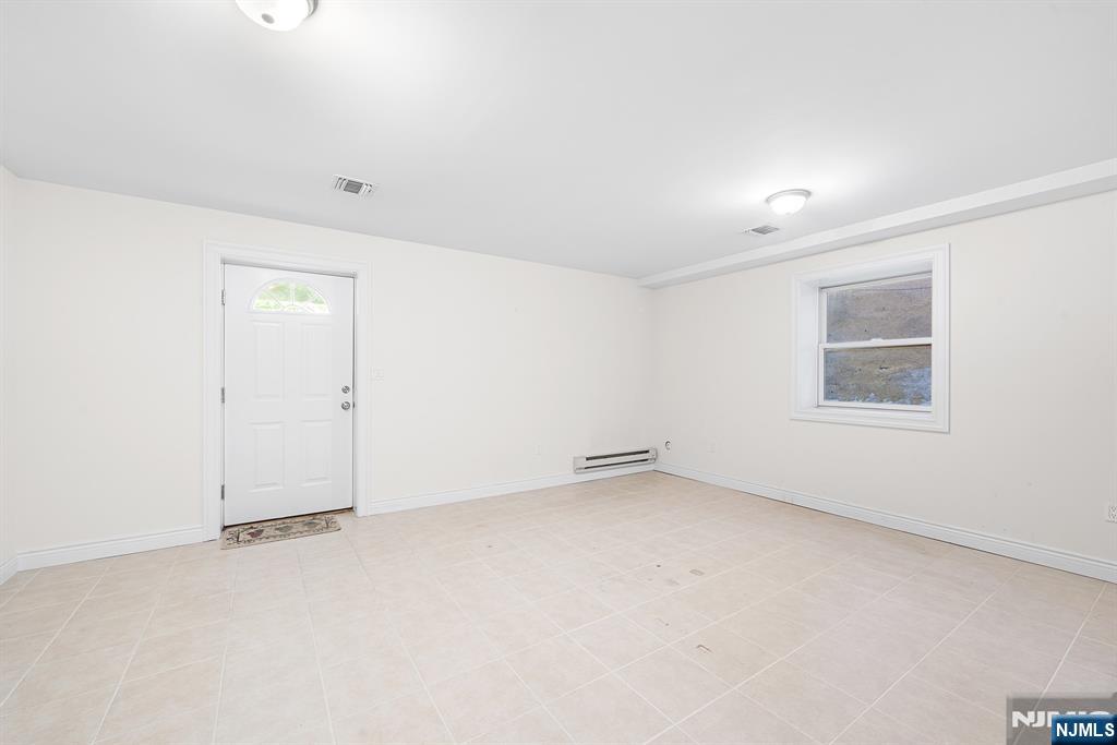 233 5th Street, Unit B Fairview, NJ 07022 - Photo 27 of 31 an empty room with a empty space and windows