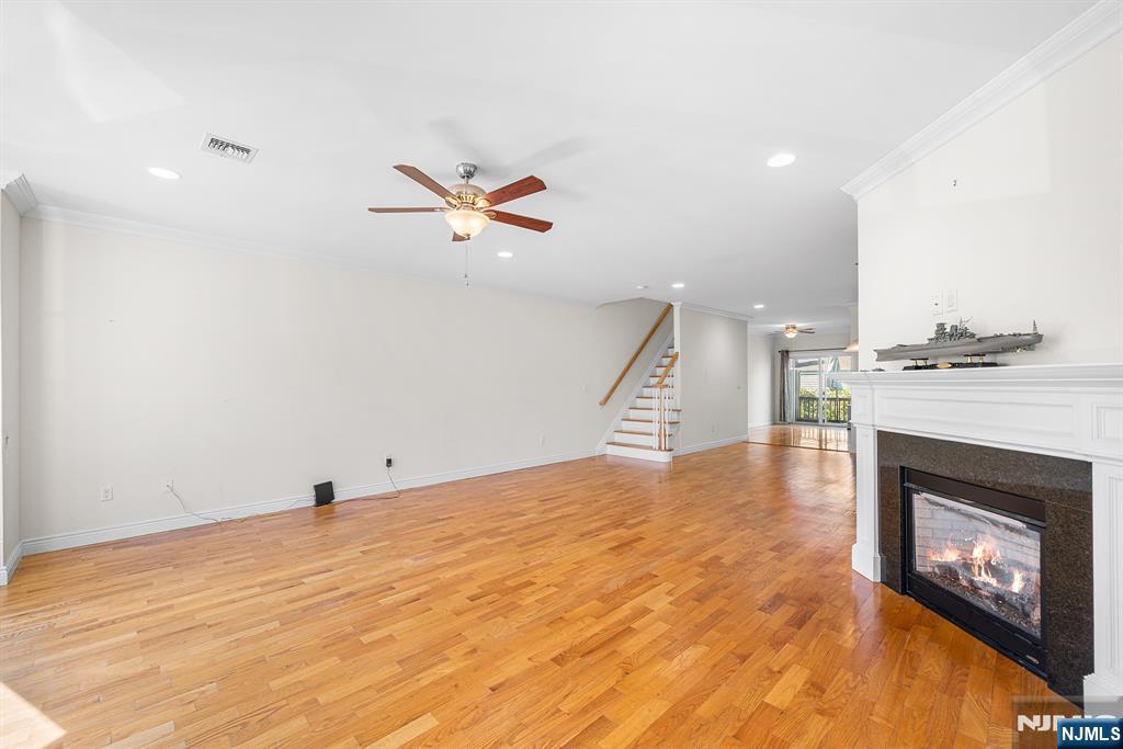 233 5th Street, Unit B Fairview, NJ 07022 - Photo 4 of 31 a view of an empty room with a fireplace