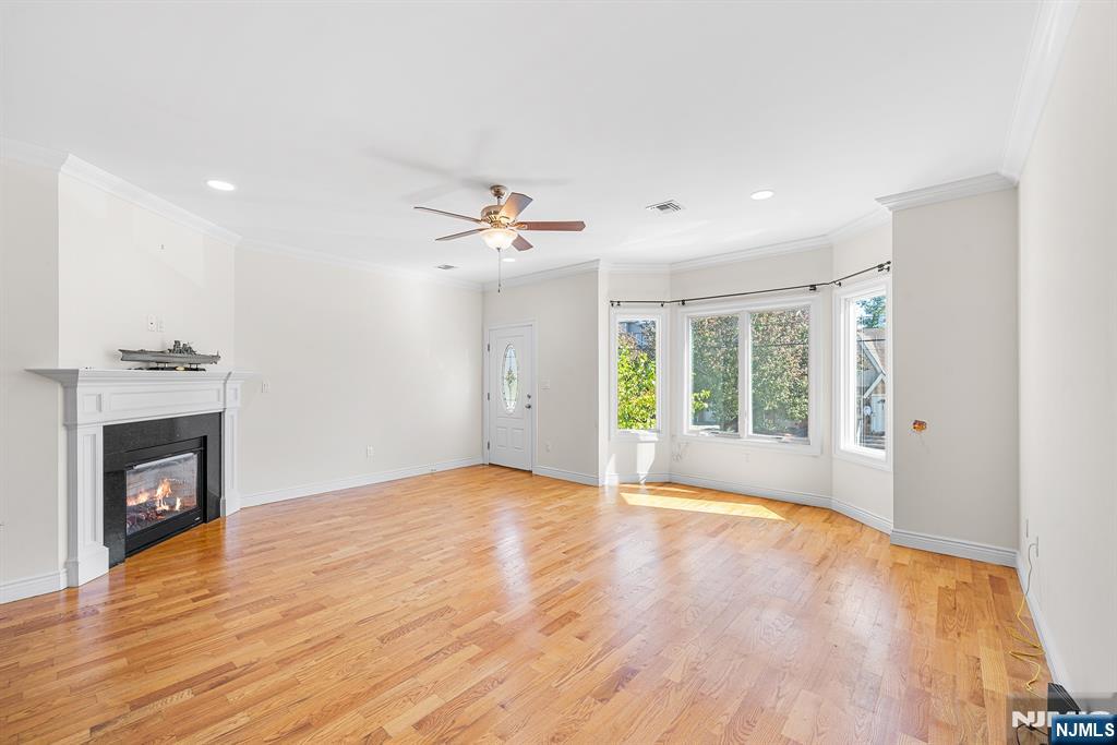 233 5th Street, Unit B Fairview, NJ 07022 - Photo 5 of 31 a view of an empty room with a fireplace and a window