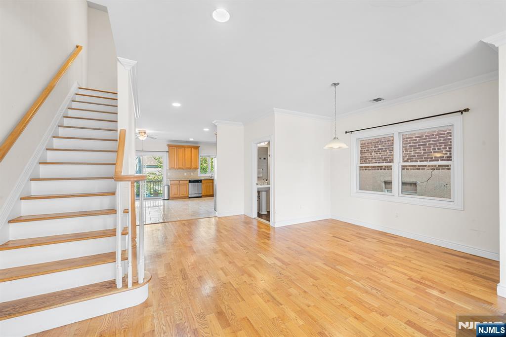 233 5th Street, Unit B Fairview, NJ 07022 - Photo 6 of 31 a view of an empty room with wooden floor and windows