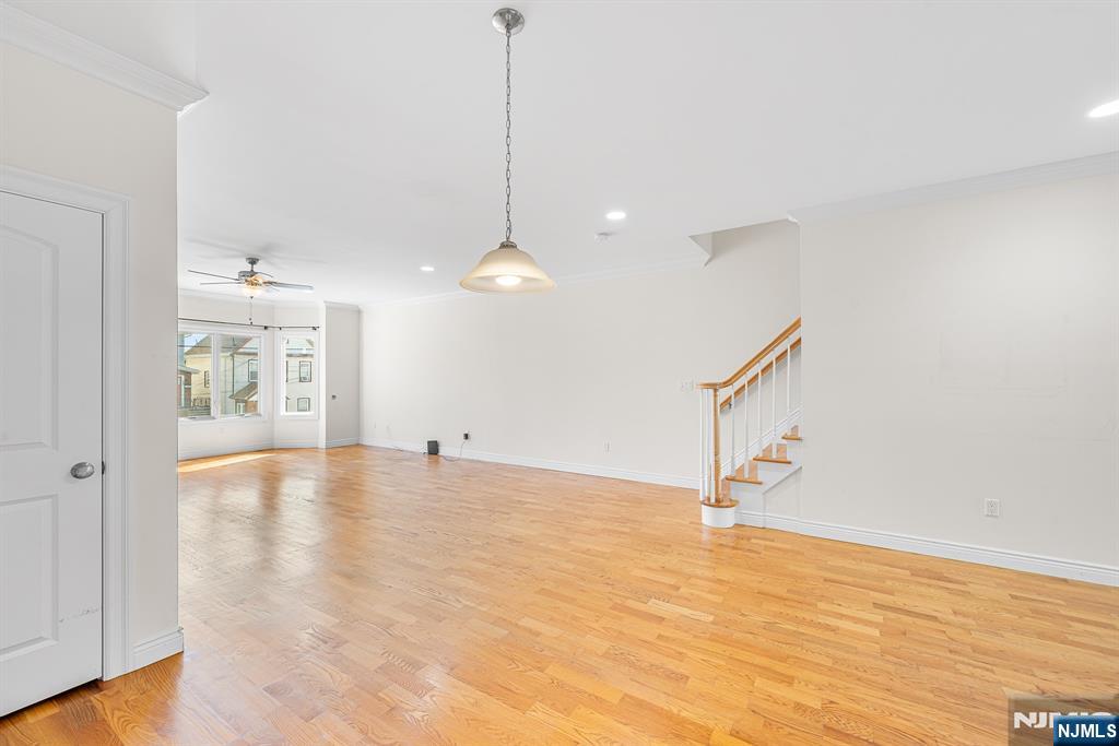 233 5th Street, Unit B Fairview, NJ 07022 - Photo 7 of 31 a view of an empty room with window and wooden floor