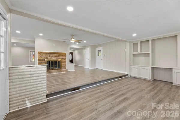 a view of a kitchen with a sink and a refrigerator