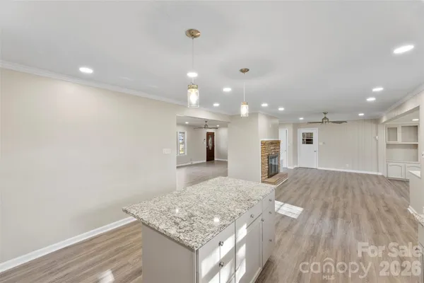 a view of kitchen and hall with wooden floor