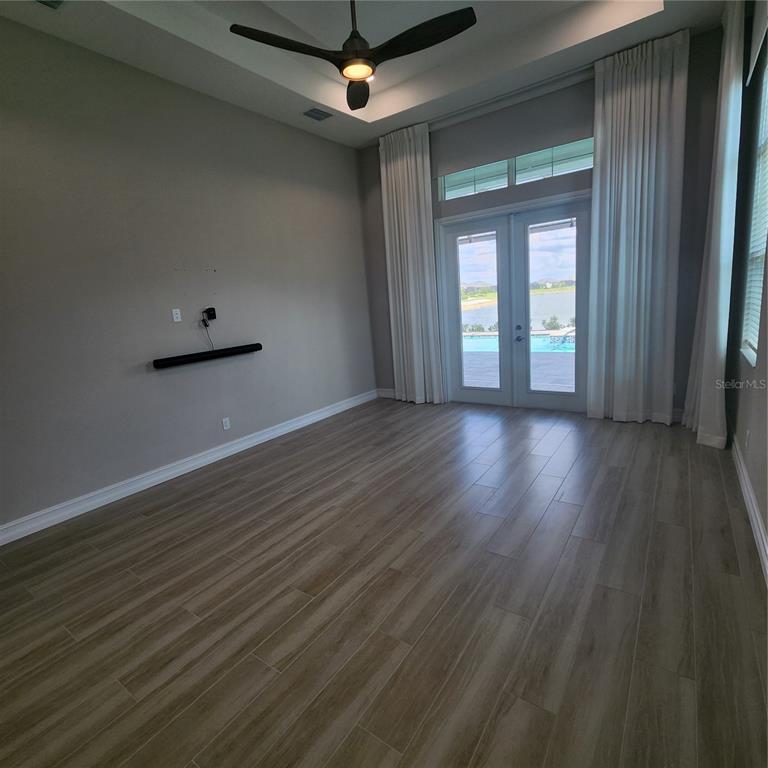 512 Blue Shell Loop Sarasota, FL 34240 - Photo 18 of 44 a view of an empty room with wooden floor and a window