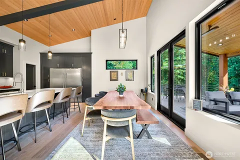 a dining room with furniture and wooden floor