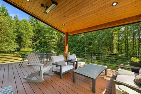 a view of a chairs and table in the balcony