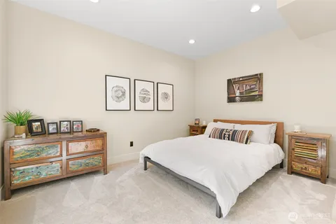 a bedroom with a bed and a night stand