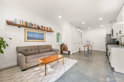 a living room with furniture and a kitchen view