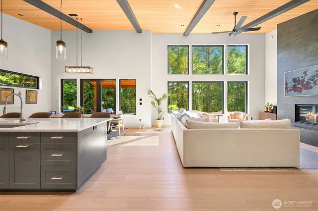 a living room with large window and a table