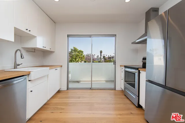 a kitchen with a refrigerator sink and stove