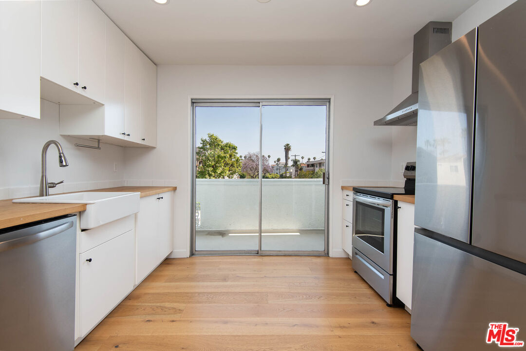 a kitchen with a refrigerator sink and stove