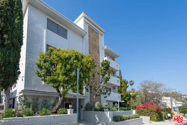 front view of a house with a tree