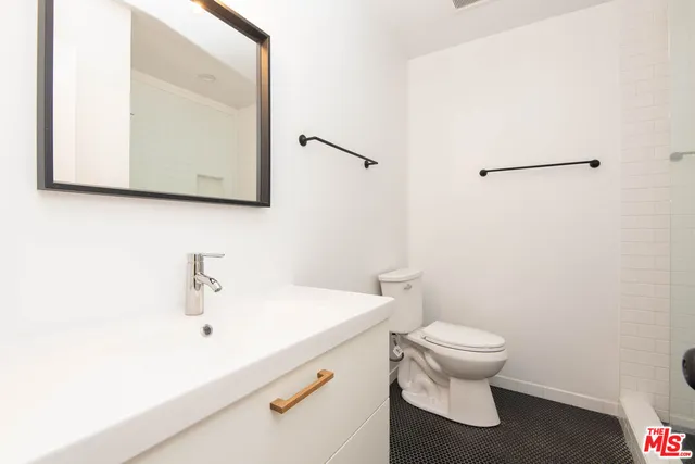 a white toilet sitting next to a bathroom sink