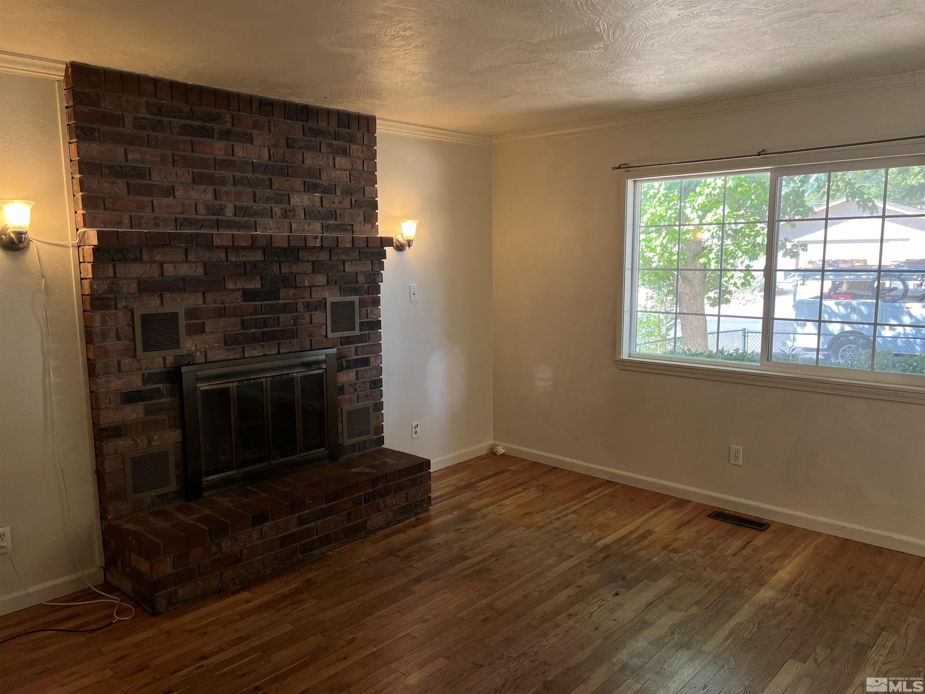 1430 Exeter Way Reno, NV 89503 - Photo 5 of 7 a view of an empty room with wooden floor and a window