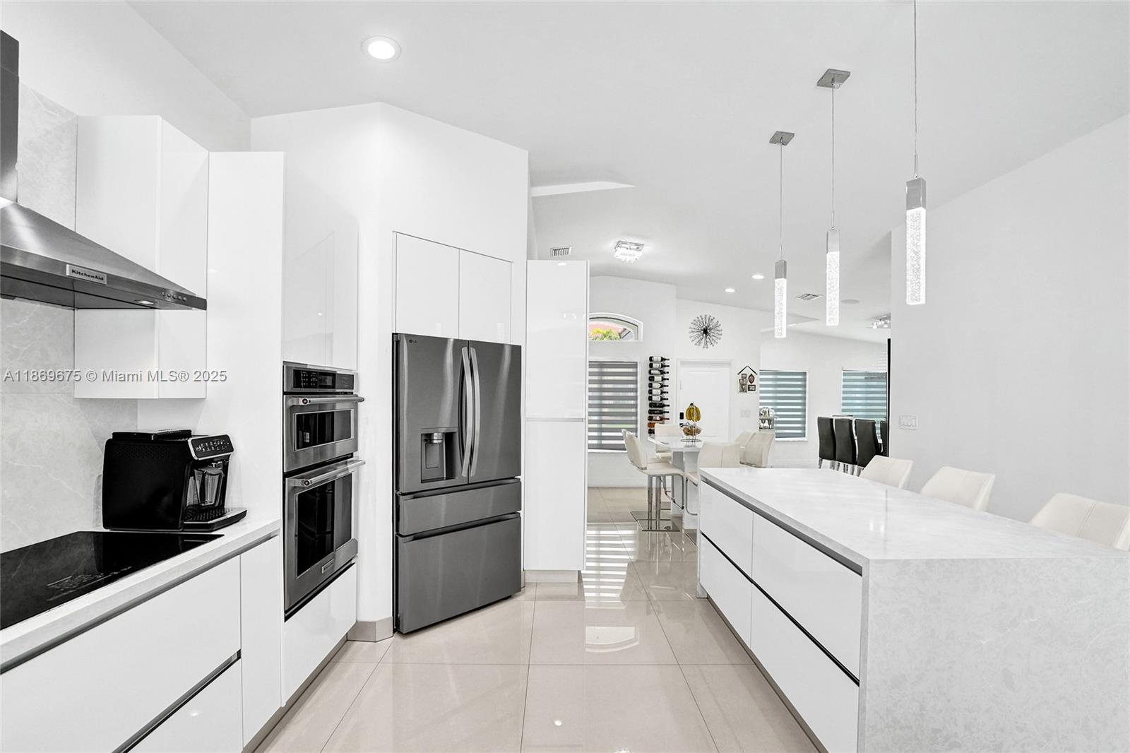 1636 Southwest 108th Terrace Davie, FL 33324 - Photo 17 of 92 a kitchen with a sink a microwave a refrigerator and cabinets