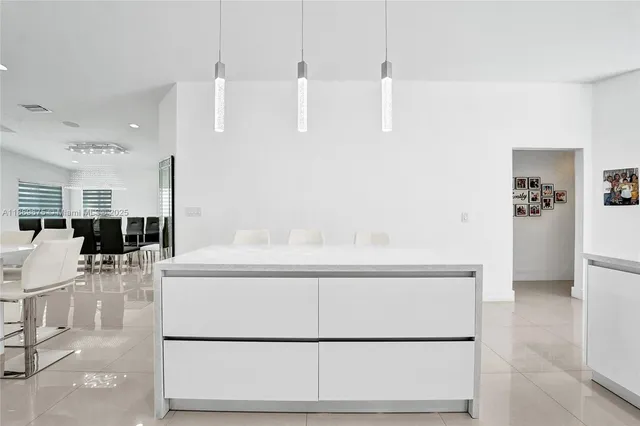 a view of a patio with a table and chairs under an umbrella