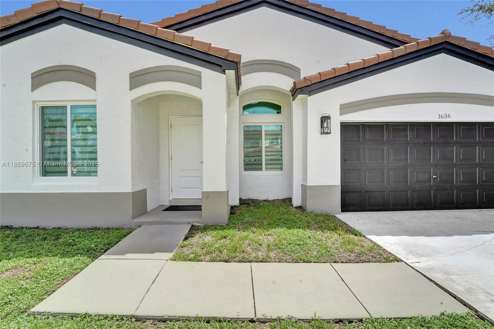1636 Southwest 108th Terrace Davie, FL 33324 - Photo 2 of 92 a front view of a house with a yard