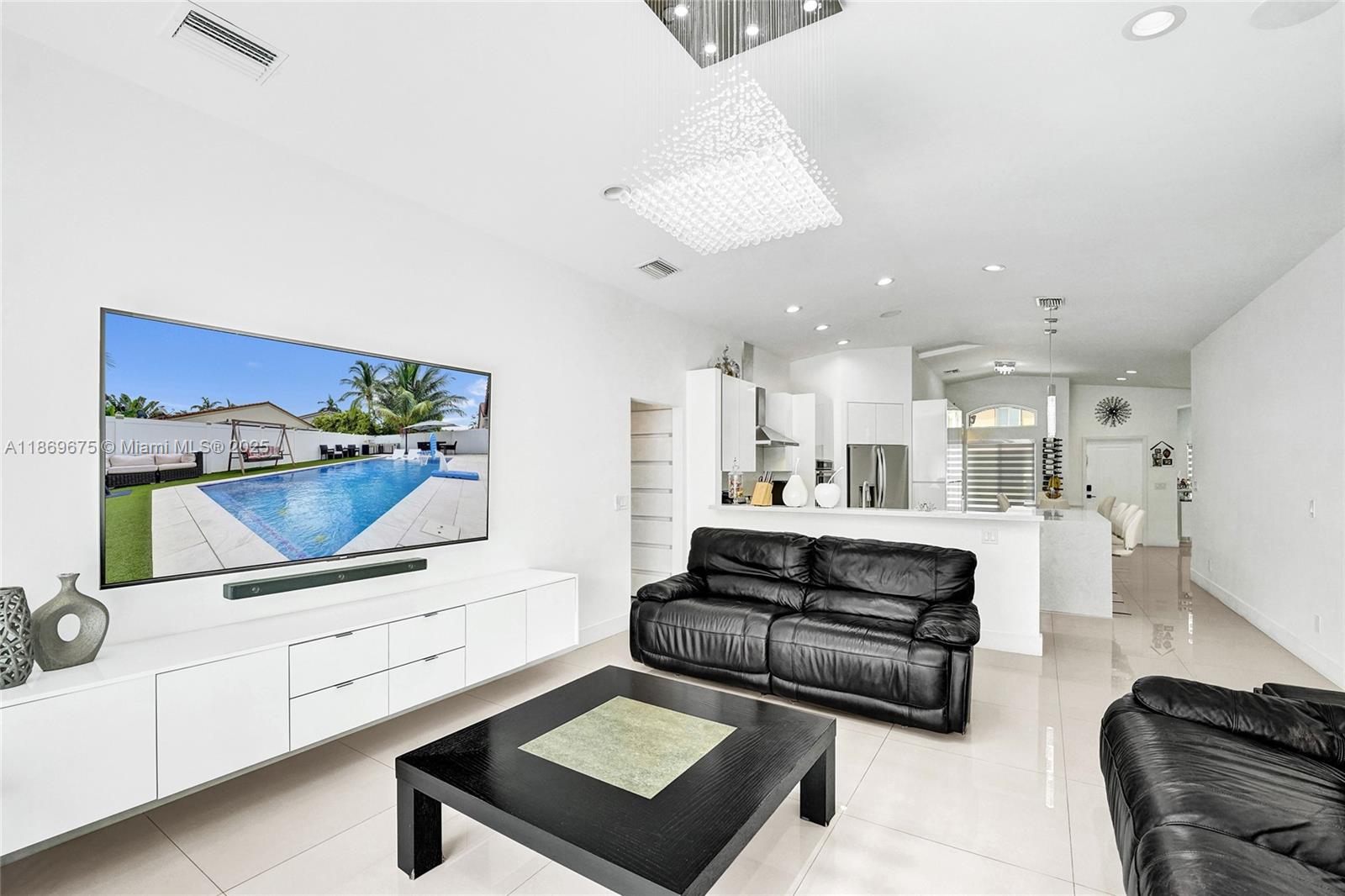 1636 Southwest 108th Terrace Davie, FL 33324 - Photo 32 of 92 a living room with furniture and a flat screen tv