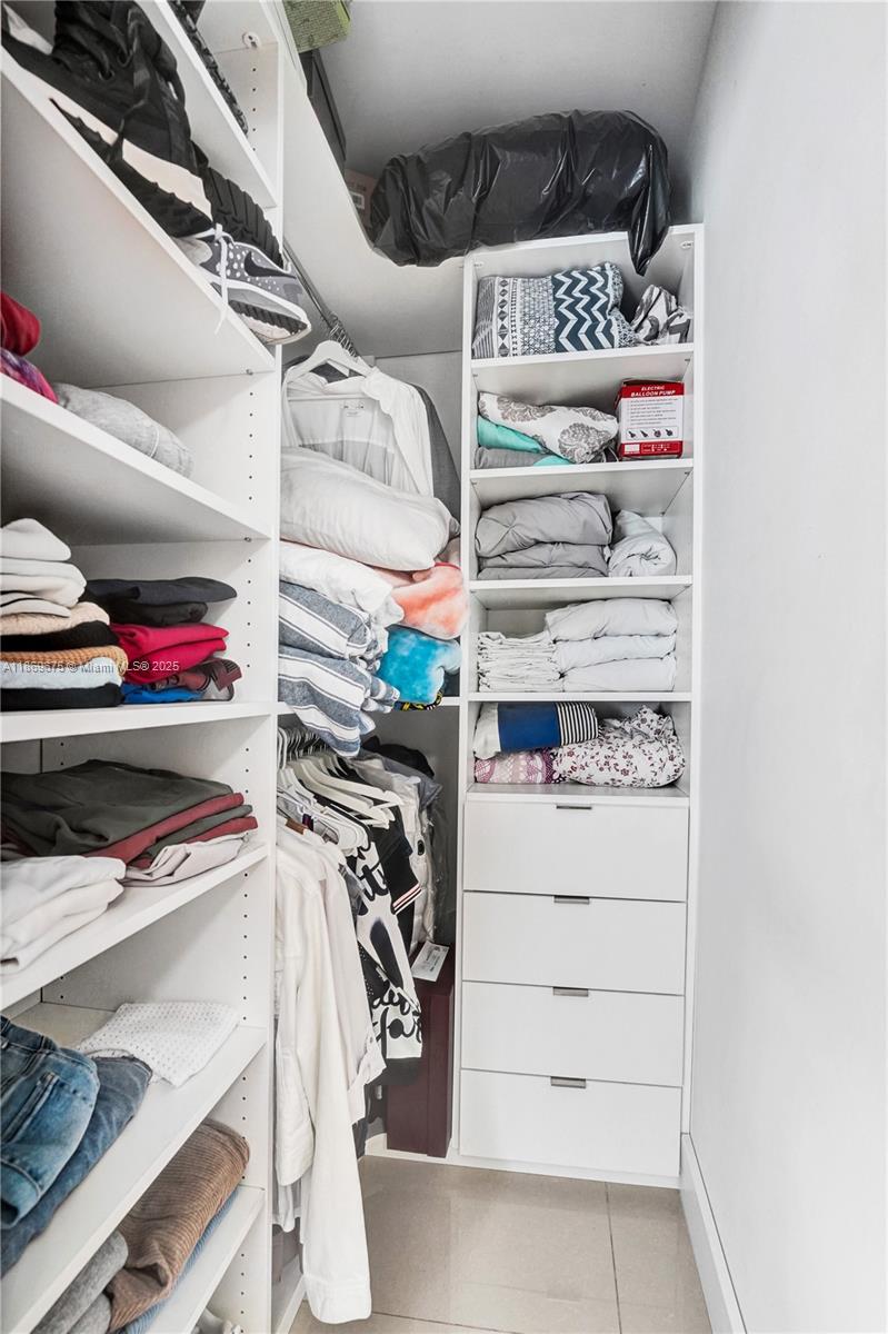 1636 Southwest 108th Terrace Davie, FL 33324 - Photo 46 of 92 a view of walk in closet with clothes and shoes