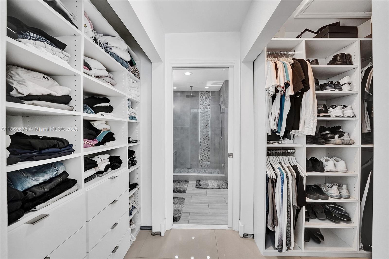 1636 Southwest 108th Terrace Davie, FL 33324 - Photo 57 of 92 a view of walk in closet with clothes and shoes