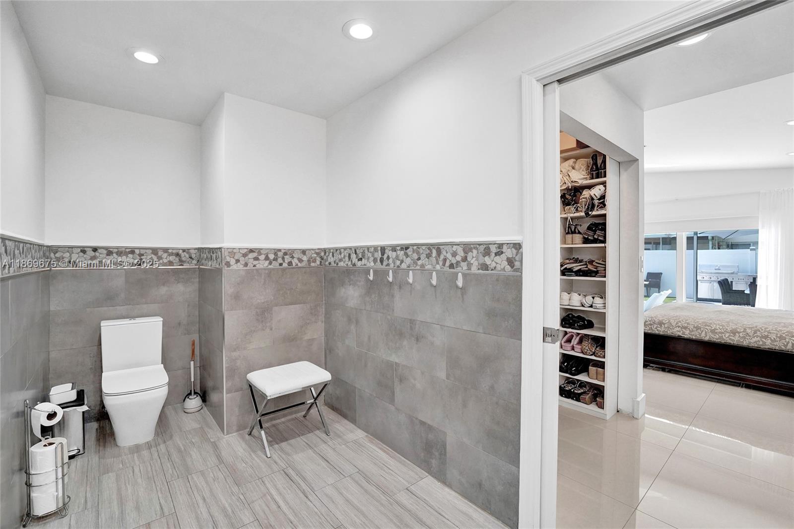 1636 Southwest 108th Terrace Davie, FL 33324 - Photo 62 of 92 a bathroom with a toilet a sink and mirror